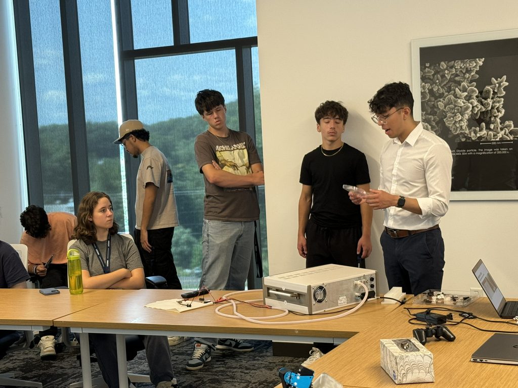Lab alumni, Dom Flores, presents to students about the power electronics of soft robotic actuators.